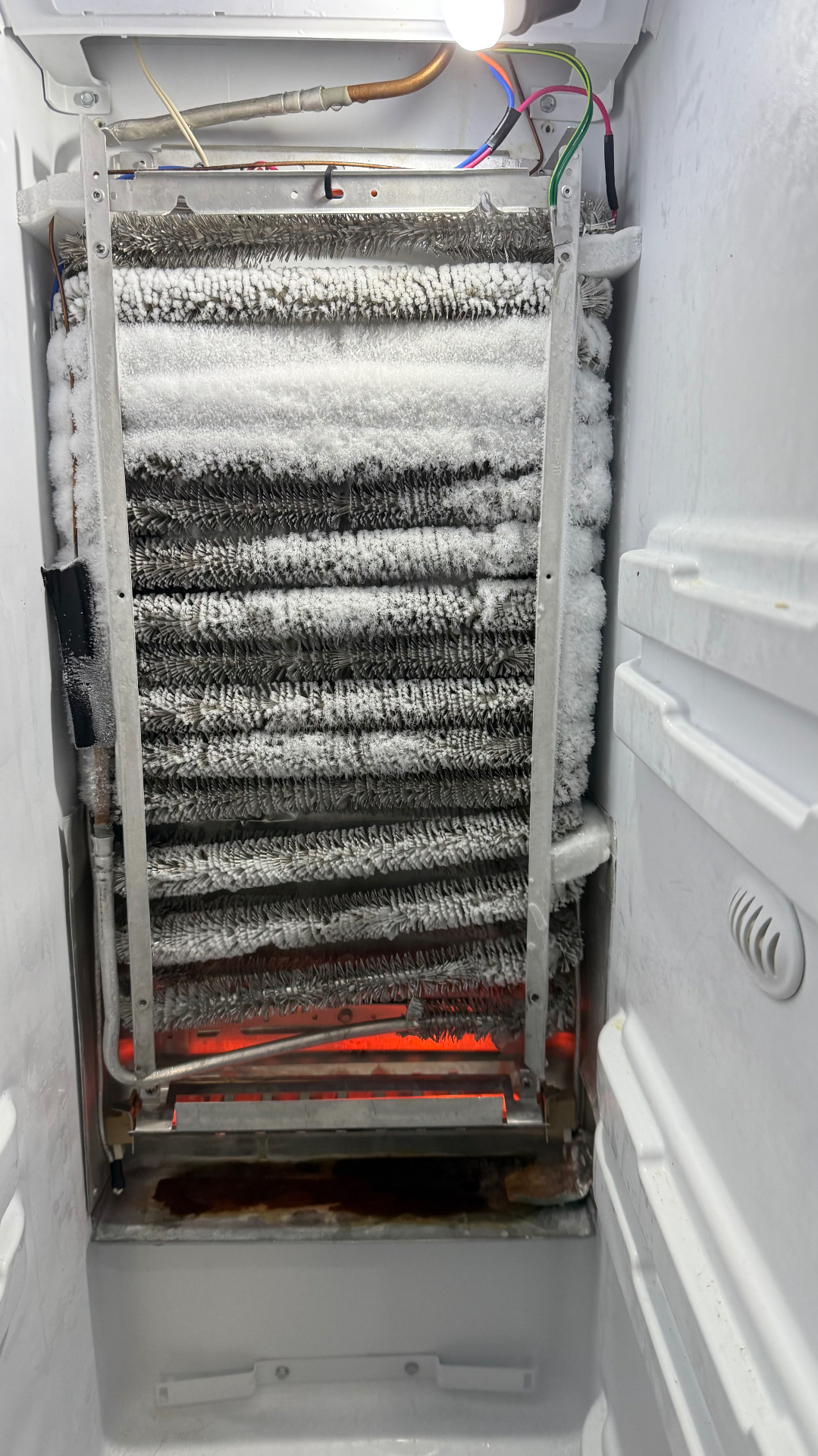 Frosted evaporator coil showing defrost issue diagnosis